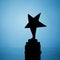 Star trophy silhouette, blue background