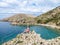 Stara Baska - A girl sitting on a rock with Stara BaskaBeach view