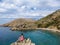 Stara Baska - A girl sitting on a rock with Stara BaskaBeach view