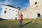 Stara Lubovna, Slovakia - December 2019: woman in red coat taking picture of Lubovniansky Hrad castle ruins