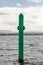 Starboard hand green spar buoy with light on top, close up