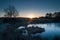 A starburst of dawn light breaking on a frozen pond on Wetley Moor.