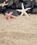 Starfish black stones and sand