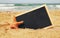 Starfish and chalkboard, on sea sand and ocean horizon