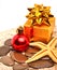 Starfish, christmas baubles, gift boxes on the sand
