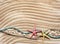 Starfish and colored ropes on a background of wavy sand. Marine cruise theme. Top view with place for text