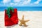 Starfish with gift bag on the beach - holiday concept