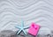 Starfish, gift and fishnet on the sand