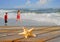 Starfish and Kids next to ocean