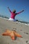 Starfish and tranquil woman on the beach