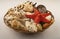 Starfish and various shells in a wicker basket on a white background. Close up