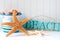 Starfish and wooden beach sign