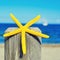 Starfish on a wooden pole on the beach