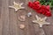 Starfishes, shells and red roses on a wooden background