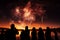 Starry explosions People watch in silhouette as fireworks light up