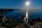 Starry night with a full moon over sea, yachts and rocks in front. Cape Fiolent, Orest and Pilad rocks on the background of the