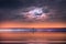 Starry night at sea , blue  pink cloudy sky sunset light reflection on water wave reflection on horizon boat  tropical   skyline