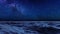 Starry night sky with milky way over ocean surface