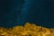 Starry Night Sky over Rocky Landscape at night