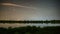 Starry night sky with stars moving over small lake in New Zealand nature Astronomy Time lapse