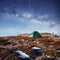 The starry sky above the tent in the mountains. Magic event in f