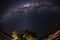 Starry sky and Milky Way arc, with details of its bright colorful core, captured with fisheye lens from the Namib desert in