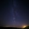 Starry sky and Milky Way on background of hill.