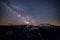 Starry sky with milky way over Caucasian mountains and observatory