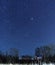 Starry sky over a country house