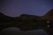 Starry sky reflected in a small lake in the mountains