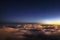 Stars above cumulus clouds in the rays of the setting sun