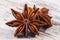 Stars of dried anise Illicium verum on wooden plank