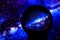 Stars of the Milky Way galaxy are reflected in a crystal ball