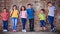 Start the bond young and watch it prosper. a diverse group of children standing against a wall outside.