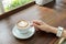 Start The Day with Good Cup of Coffee Concept. Perspective View Business Asian Woman Hand Holding Cup of Cappuccino Coffee