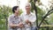 Start day with morning coffee, Asian senior retired couple sitting in green copy space