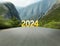 Start of new 2024 year. Asphalt road leading to numbers, motion effect