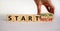 Start now or never symbol. Businessman turns wooden cubes and changes words `start never` to `start now`. Beautiful white
