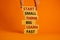 Start small think big symbol. Words `Start small think big learn fast` on wooden blocks on a beautiful orange background.