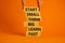 Start small think big symbol. Words `Start small think big learn fast` on wooden blocks on a beautiful orange background.