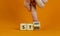 Start strong symbol. Businessman turns wooden cubes with words `start strong`. Beautiful orange background, copy space. Business