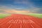 Start to Success written on running track written on Running track with green grass and blue sky white cloud background.