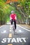 Start word on road with sportswoman ride bike on countryside with tree tunnel