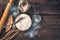 Starter sourdough. Sourdough, flour, water and wheat on a brown wooden background.