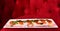 Starter from traditional Italian cuisine on red quilted background.