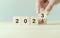 Starting new year 2024. Flipping of 2023 to 2024 on wooden cube blocks. Beginning and start of the new year 2024