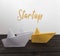 Startup concept. Paper boats on wood with inscription: Comfort zone.