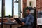 Startup employee holding clipboard with bussiness charts sitting at desk comparing data