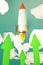 Startup rocket green arrows