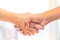 startup standing handshake together.business people joining for cooperation.startup shaking hands to deal with partner.side view